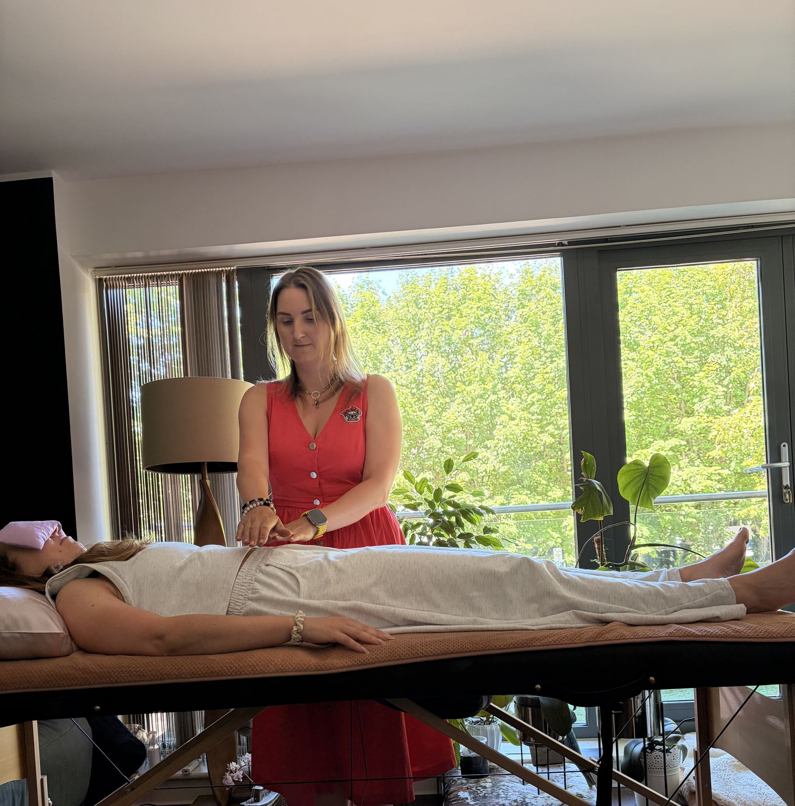 Anna performing a hands-on Reiki session for a client at home